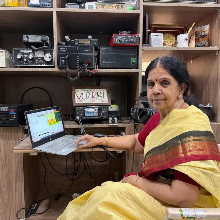 Bharathi Devulapalli (VU2RBI) at her Hyderabad station — laptop logging beside the transceiver stack and her VU2RBI nameplate